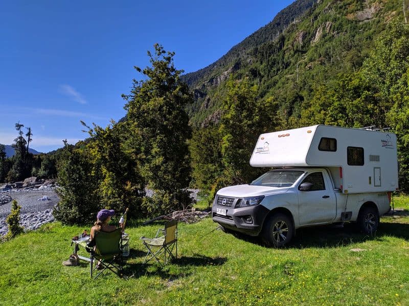 4x4 camper crossing the Carretera Austral between evergreen forests